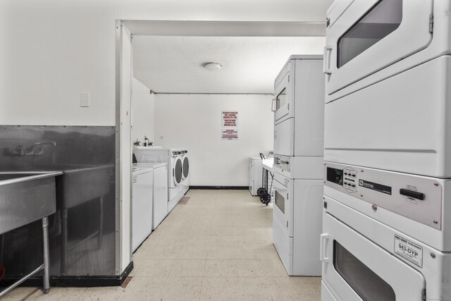 79 Claudia Dr Apt 254, West Haven, CT 06516 - shared laundry featuring stacked washer and clothes dryer, light flooring, and washer and clothes dryer