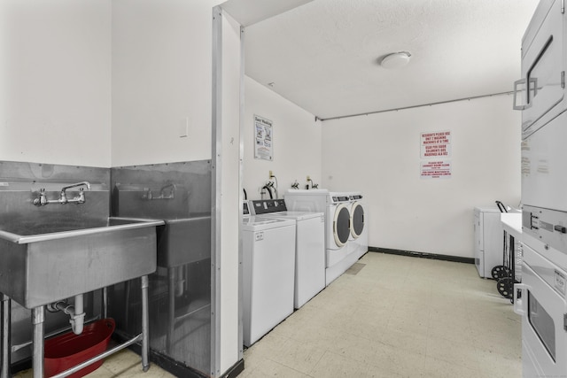79 Claudia Dr Apt 254, West Haven, CT 06516 - community laundry room featuring washing machine and clothes dryer, light floors, and stacked washer / dryer