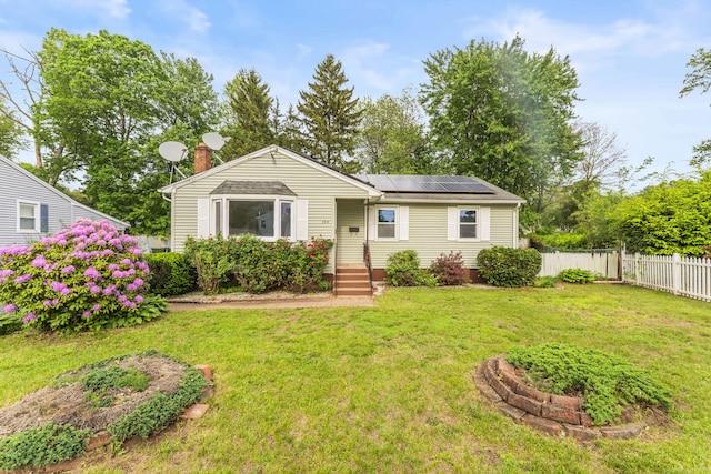 130 Jefferson Ln, East Hartford, CT 06118 - view of front of house with roof mounted solar panels and a chimney