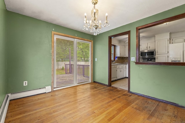 130 Jefferson Ln, East Hartford, CT 06118 - unfurnished room featuring a chandelier, light wood-style floors, baseboards, baseboard heating, and a baseboard heating unit