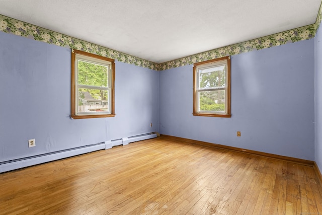 130 Jefferson Ln, East Hartford, CT 06118 - empty room featuring plenty of natural light, hardwood / wood-style flooring, baseboard heating, and baseboards