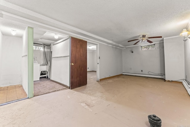 130 Jefferson Ln, East Hartford, CT 06118 - basement with a baseboard radiator, a textured ceiling, washer / dryer, ceiling fan, and healthy amount of natural light