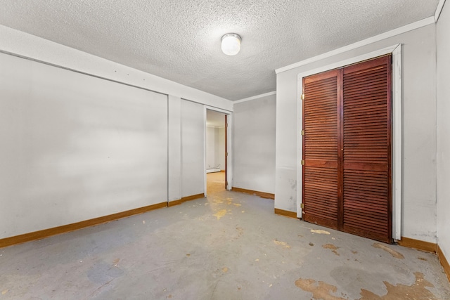 130 Jefferson Ln, East Hartford, CT 06118 - unfurnished bedroom featuring concrete flooring, a textured ceiling, baseboards, and a closet