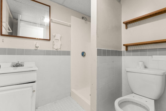130 Jefferson Ln, East Hartford, CT 06118 - full bath with tile walls, vanity, a shower stall, toilet, and a wainscoted wall
