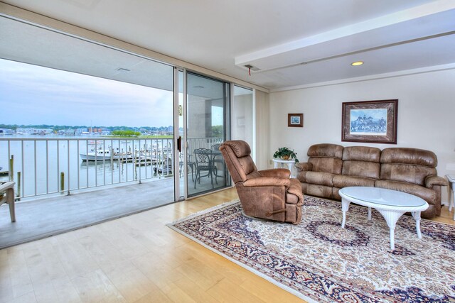 26 Cove Ave Apt 3B, Norwalk, CT 06855 - living area with wood finished floors, a water view, expansive windows, and recessed lighting