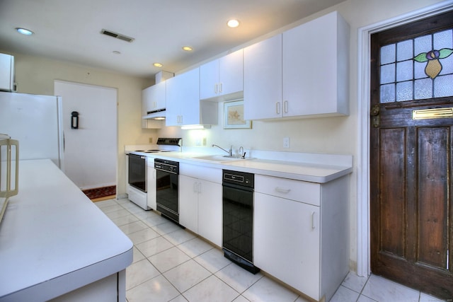 26 Cove Ave Apt 3B, Norwalk, CT 06855 - kitchen with freestanding refrigerator, range with electric cooktop, a sink, light countertops, and white cabinetry