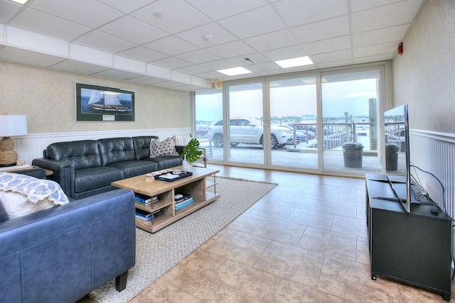 26 Cove Ave Apt 3B, Norwalk, CT 06855 - tiled living area with healthy amount of natural light, a paneled ceiling, a wainscoted wall, and expansive windows