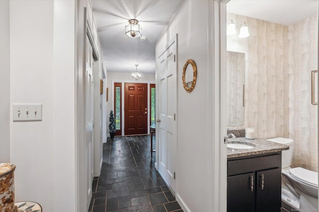33 Cold Spring Rd, Avon, CT 06001 - hallway featuring a sink, stone tile floors, and a chandelier