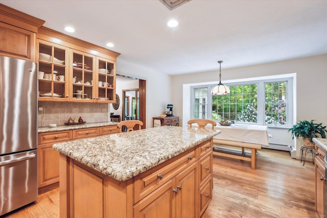 33 Cold Spring Rd, Avon, CT 06001 - kitchen with freestanding refrigerator, light wood-style floors, a kitchen island, glass insert cabinets, and tasteful backsplash
