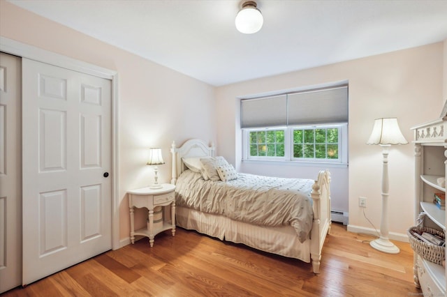 33 Cold Spring Rd, Avon, CT 06001 - bedroom with a baseboard heating unit, light wood-type flooring, and baseboards