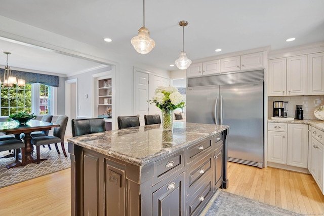 15 Stony Cors, Avon, CT 06001 - kitchen with built in fridge, light wood-type flooring, white cabinetry, decorative light fixtures, and recessed lighting
