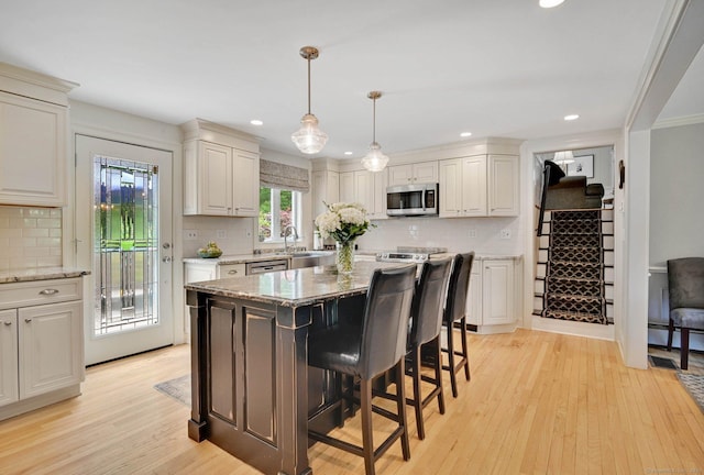 15 Stony Cors, Avon, CT 06001 - kitchen with appliances with stainless steel finishes, backsplash, light wood-style flooring, ornamental molding, and recessed lighting