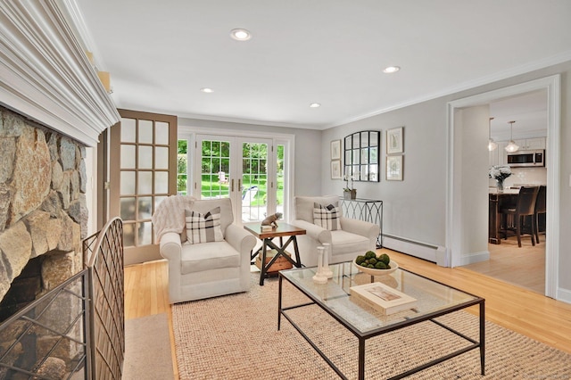 15 Stony Cors, Avon, CT 06001 - living room with a baseboard heating unit, crown molding, light wood-type flooring, a fireplace, and french doors