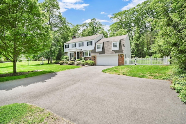 15 Stony Cors, Avon, CT 06001 - view of front of house featuring driveway, an attached garage, a chimney, brick siding, and roof with shingles