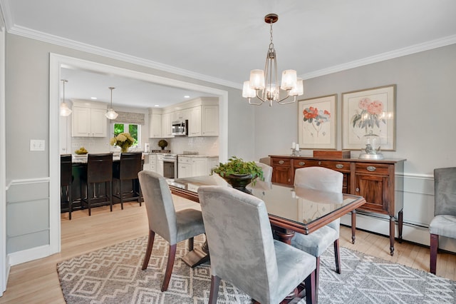 15 Stony Cors, Avon, CT 06001 - dining space featuring a chandelier, light wood finished floors, ornamental molding, and a baseboard heating unit