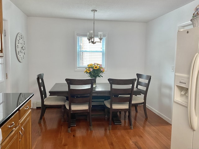 10 Richards Ave, Seymour, CT 06483 - dining room with a chandelier, hardwood / wood-style floors, baseboards, and a baseboard heating unit