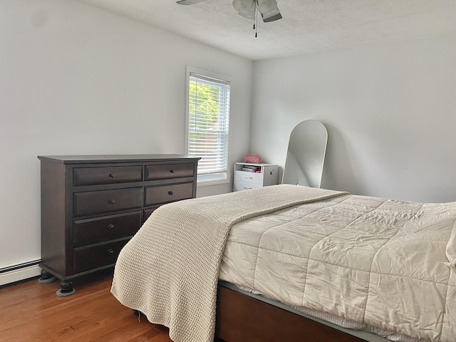 10 Richards Ave, Seymour, CT 06483 - bedroom with wood finished floors, a baseboard heating unit, a textured ceiling, and a ceiling fan