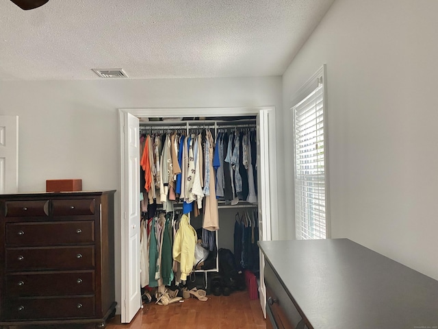 10 Richards Ave, Seymour, CT 06483 - bedroom featuring dark wood-style flooring, a textured ceiling, and a closet