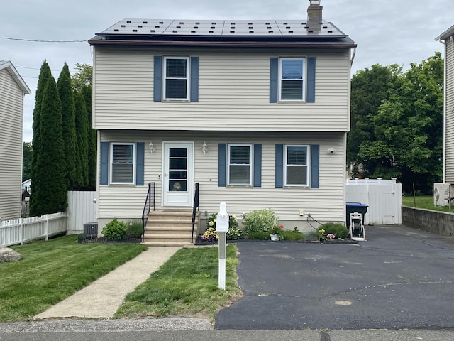 10 Richards Ave, Seymour, CT 06483 - colonial house with entry steps, roof mounted solar panels, a chimney, and cooling unit