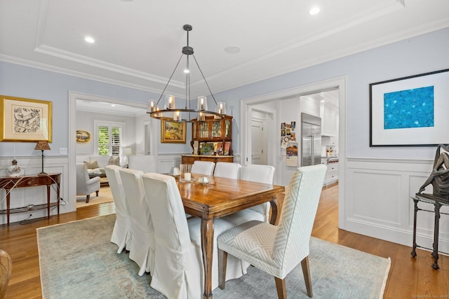 5 Oakleigh Ct, Norwalk, CT 06853 - dining room with wood finished floors, a decorative wall, crown molding, a chandelier, and a wainscoted wall