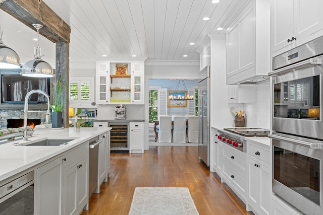 5 Oakleigh Ct, Norwalk, CT 06853 - kitchen featuring a sink, stainless steel appliances, recessed lighting, wine cooler, and white cabinets
