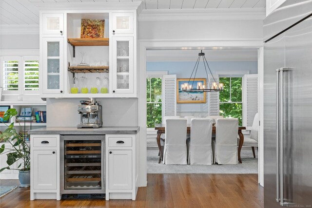 5 Oakleigh Ct, Norwalk, CT 06853 - indoor dry bar with high end refrigerator, beverage cooler, ornamental molding, a chandelier, and healthy amount of natural light