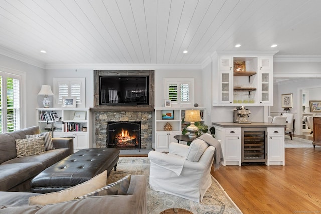 5 Oakleigh Ct, Norwalk, CT 06853 - living area featuring beverage cooler, light wood finished floors, healthy amount of natural light, crown molding, and a fireplace
