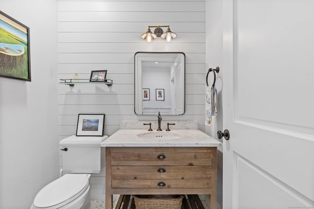 5 Oakleigh Ct, Norwalk, CT 06853 - bathroom featuring toilet, vanity, and wooden walls