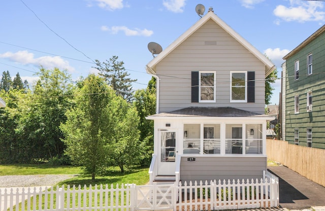 17 May St, Ansonia, CT 06401 - view of front facade featuring a fenced front yard, a sunroom, and roof with shingles