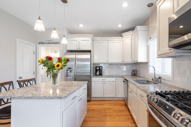 100 Silver Island Way Unit 100, Berlin, CT 06037 - kitchen featuring stainless steel appliances, a sink, a kitchen island, hanging light fixtures, and backsplash