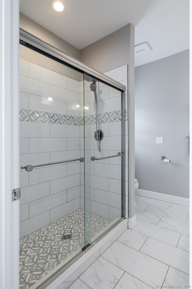 100 Silver Island Way Unit 100, Berlin, CT 06037 - bathroom with a stall shower, toilet, marble look tile flooring, and baseboards