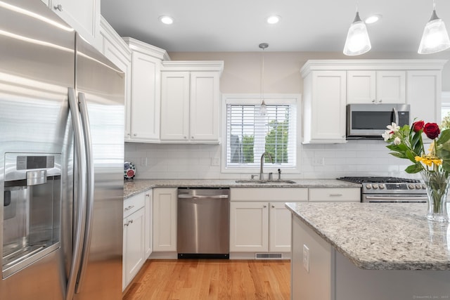 100 Silver Island Way Unit 100, Berlin, CT 06037 - kitchen with appliances with stainless steel finishes, a sink, white cabinets, light wood-type flooring, and recessed lighting