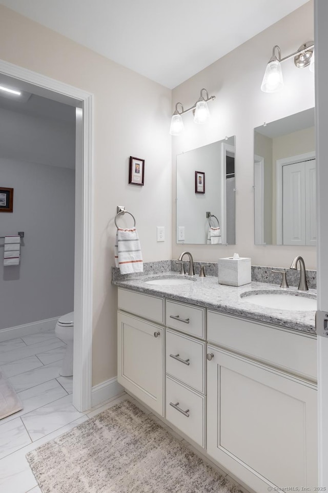 100 Silver Island Way Unit 100, Berlin, CT 06037 - full bath featuring double vanity, toilet, marble look tiles, and baseboards