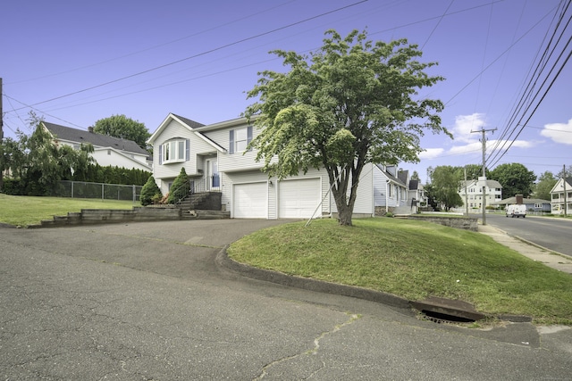 8 Lindsley St, Waterbury, CT 06708 - view of front of house with asphalt driveway, an attached garage, and a residential view