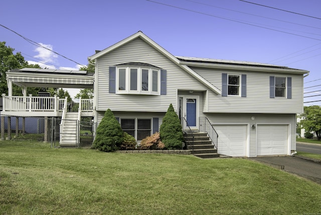 8 Lindsley St, Waterbury, CT 06708 - split foyer home featuring an attached garage, driveway, and a wooden deck