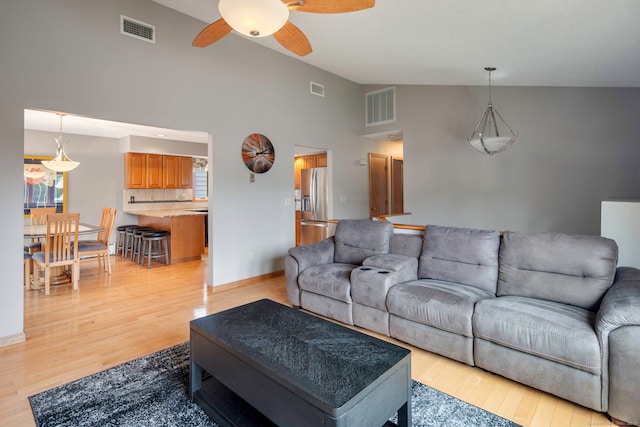 8 Lindsley St, Waterbury, CT 06708 - living room with ceiling fan, light wood-type flooring, high vaulted ceiling, and plenty of natural light
