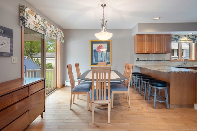 8 Lindsley St, Waterbury, CT 06708 - dining area featuring light wood-type flooring, recessed lighting, and a baseboard heating unit