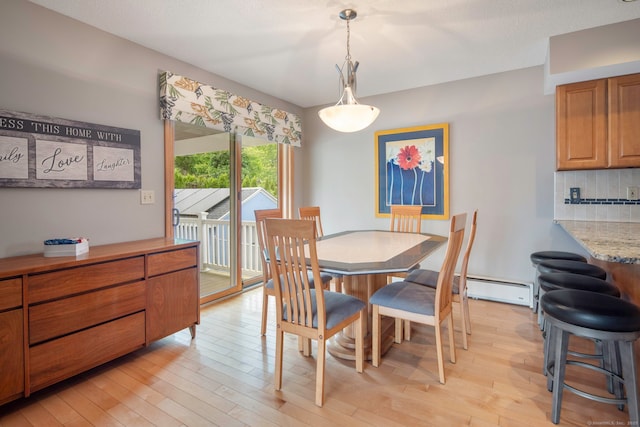8 Lindsley St, Waterbury, CT 06708 - dining space with light wood-style flooring and a baseboard radiator