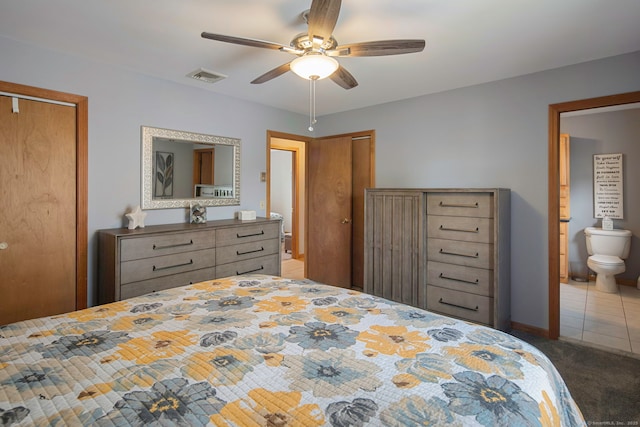 8 Lindsley St, Waterbury, CT 06708 - tiled bedroom with multiple closets, carpet, ceiling fan, and connected bathroom