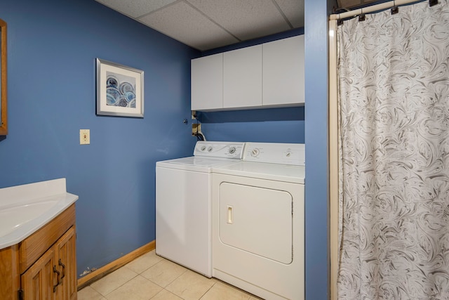 8 Lindsley St, Waterbury, CT 06708 - laundry room with cabinet space, separate washer and dryer, light tile patterned floors, and baseboards