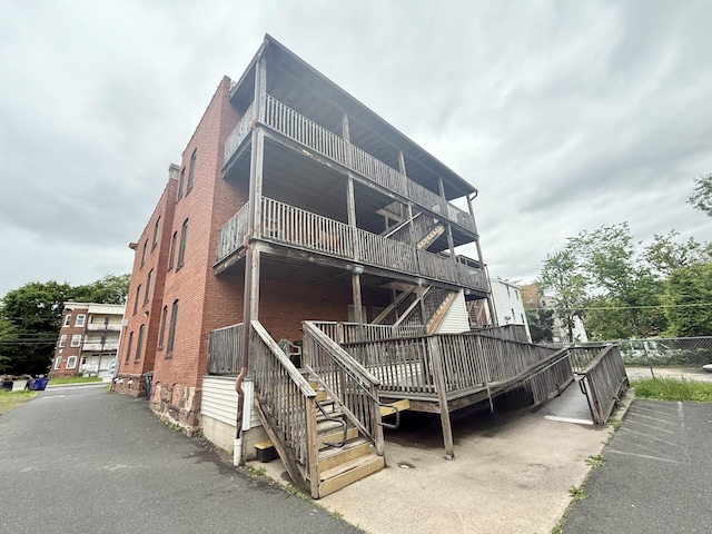 54 Edgewood St Unit A, Hartford, CT 06112 - view of front of property featuring stairs, brick siding, and a deck
