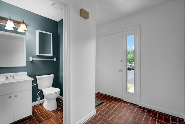 207 Summer Hill Dr Unit 207, South Windsor, CT 06074 - bathroom with vanity, brick patterned floors, and a textured ceiling