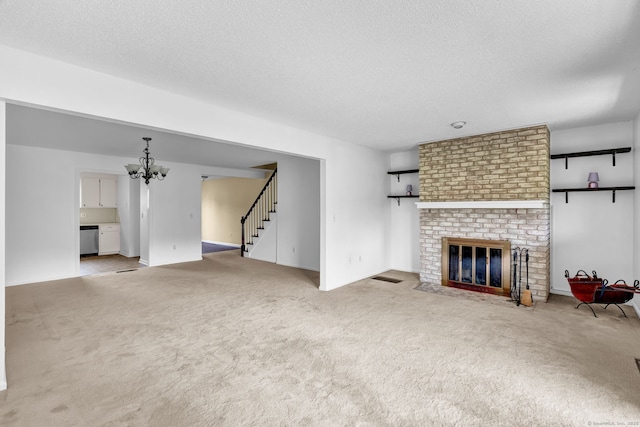 207 Summer Hill Dr Unit 207, South Windsor, CT 06074 - carpeted living area featuring a brick fireplace, a chandelier, stairs, and a textured ceiling
