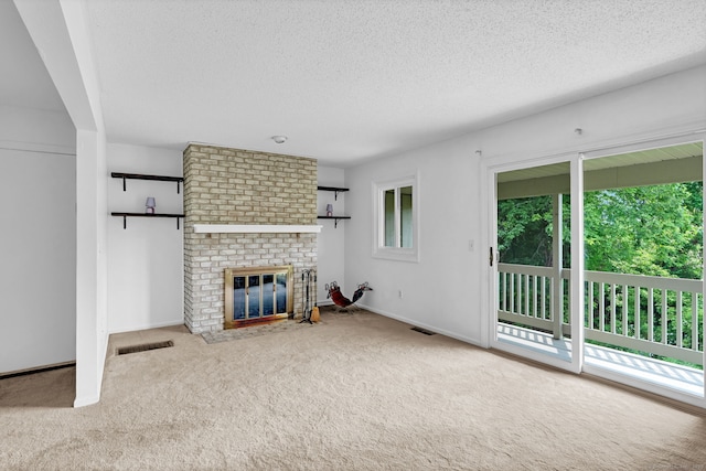 207 Summer Hill Dr Unit 207, South Windsor, CT 06074 - unfurnished living room featuring carpet floors, a textured ceiling, and a brick fireplace