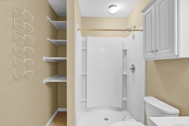 207 Summer Hill Dr Unit 207, South Windsor, CT 06074 - bathroom with a stall shower, a textured ceiling, and tile patterned floors