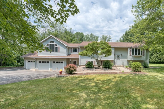 169 Dunn Rd, Coventry, CT 06238 - view of front of property featuring driveway, a front lawn, a garage, and roof with shingles