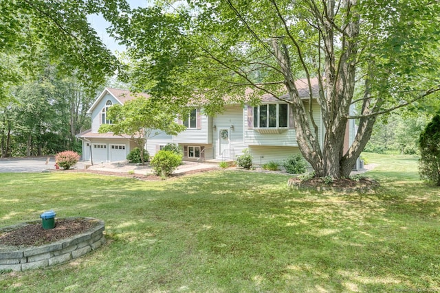 169 Dunn Rd, Coventry, CT 06238 - bi-level home with an attached garage, a front lawn, and driveway