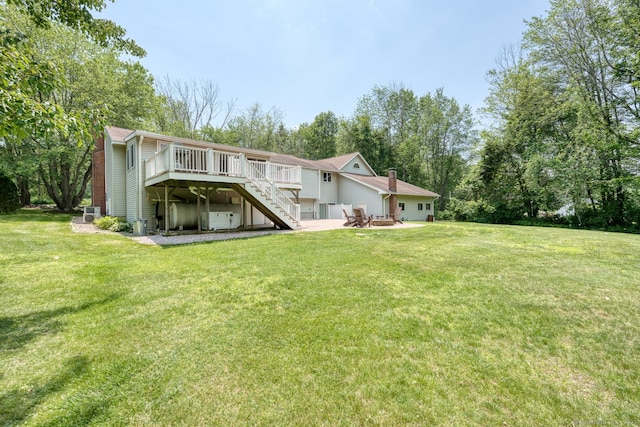 169 Dunn Rd, Coventry, CT 06238 - back of property featuring a wooden deck, stairs, a lawn, and a chimney