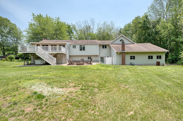 169 Dunn Rd, Coventry, CT 06238 - back of house featuring stairway, a wooden deck, an outdoor fire pit, a chimney, and a yard
