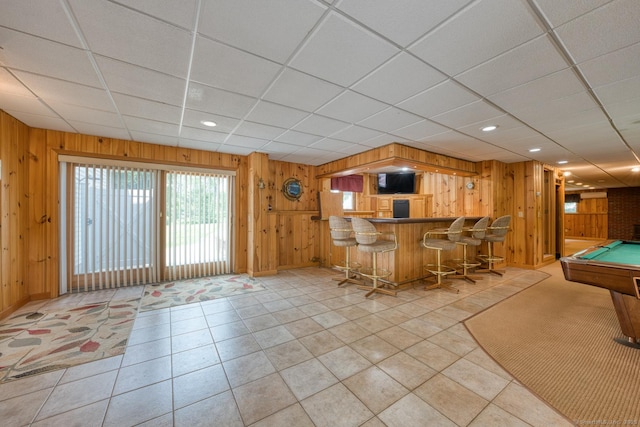 169 Dunn Rd, Coventry, CT 06238 - kitchen with wooden walls, pool table, light tile patterned flooring, a drop ceiling, and a breakfast bar area